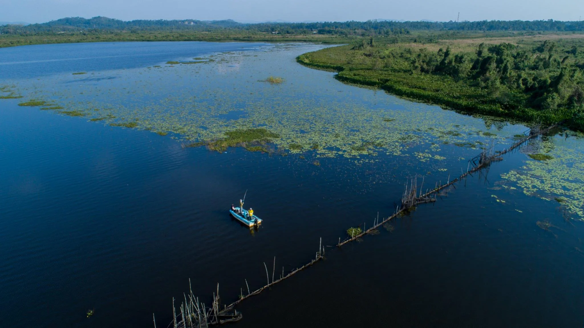 Boat fishing a winding inshore river